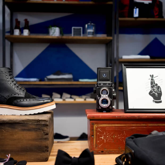 A pair of black shoes sitting on top of a wooden table.