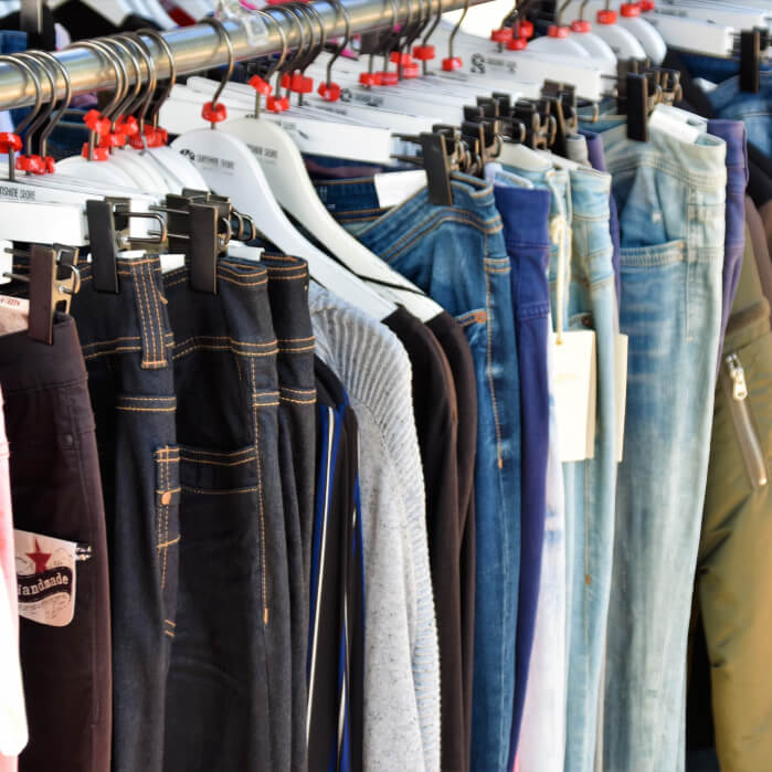 A rack of jeans hanging on a rail.
