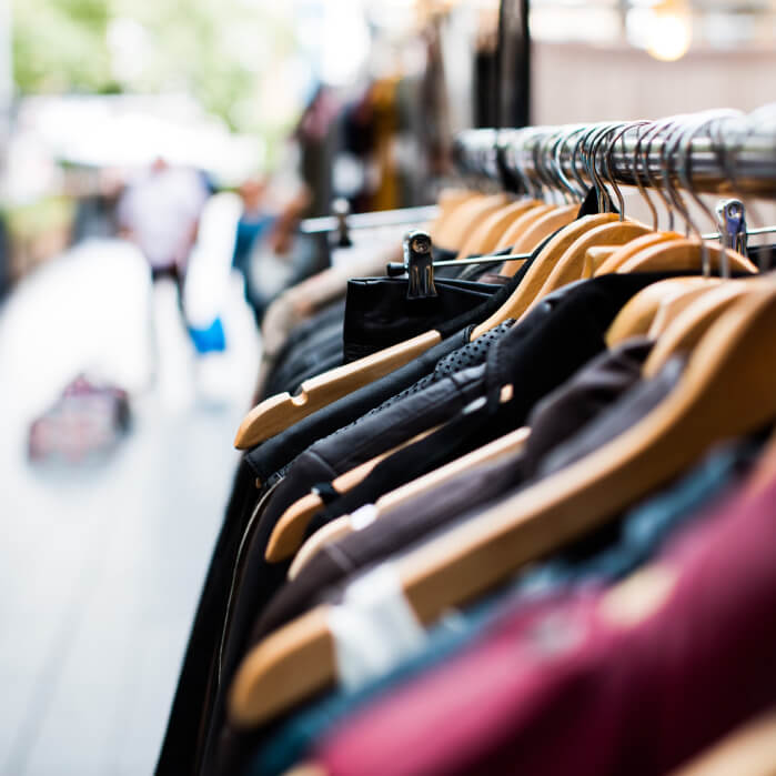 A row of clothes hanging on a rack.