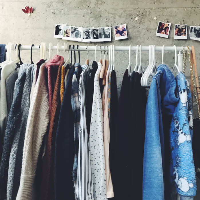 A rack of clothes hanging on a wall.