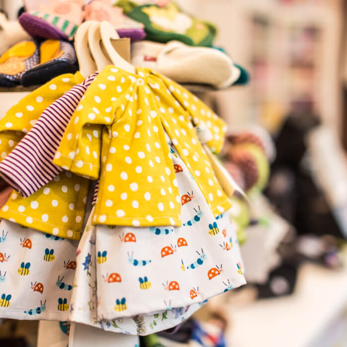 A bunch of cloths are hanging on a rack.