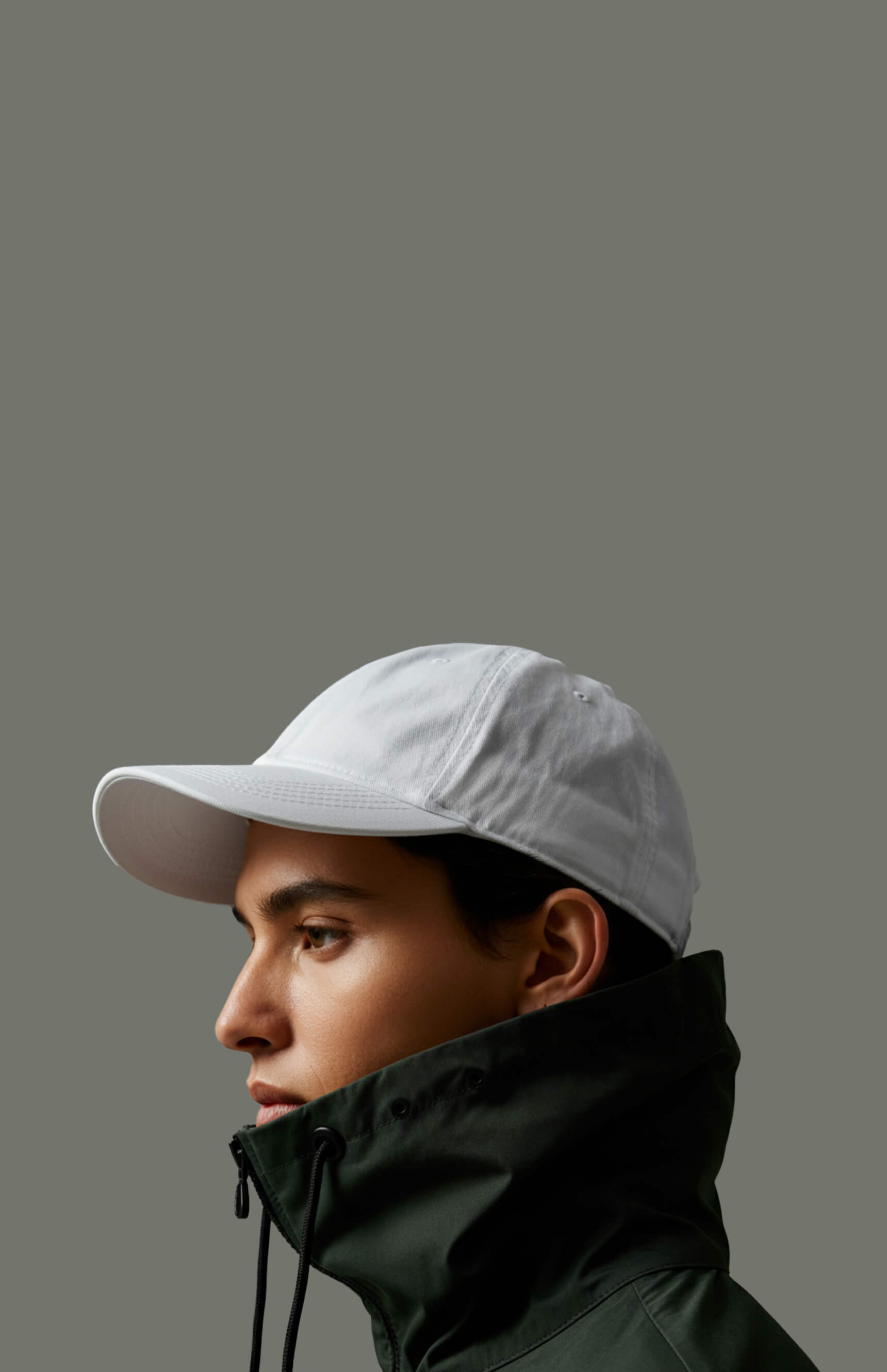 a man wearing a white hat and a green jacket